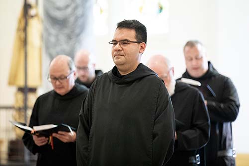 Photo of a monk sitting in the Archabbey Church