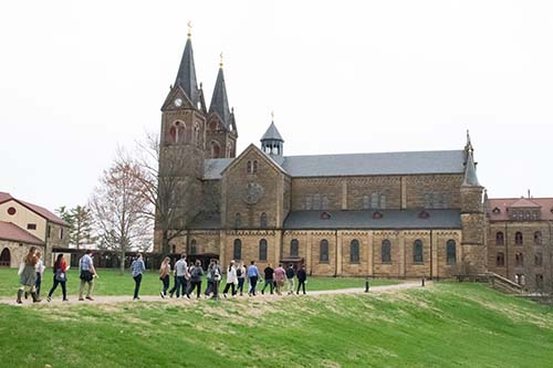 A photo of people walking on the grounds at Saint Meinrad.
